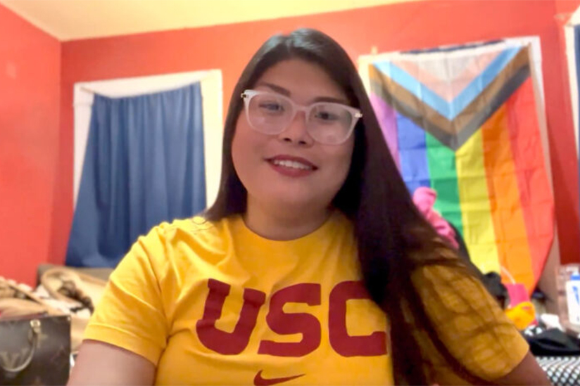 USC Student, Carla Ibarra with pride flag in background