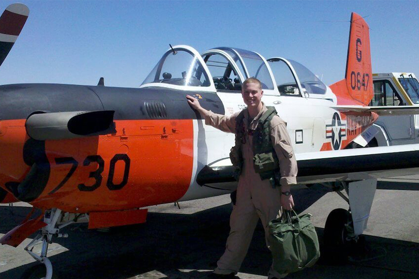 Photo of Edward Proulx next to an airplane