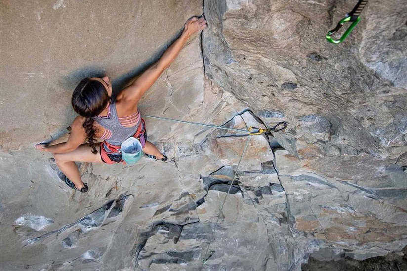 Photo of Emily Powis rock climbing.