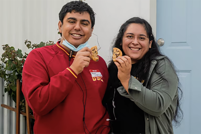 Two USC students holding cookies