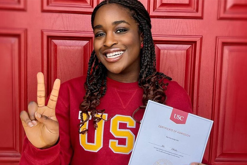 Photo of Jill Ofodu holding her USC acceptance letter.
