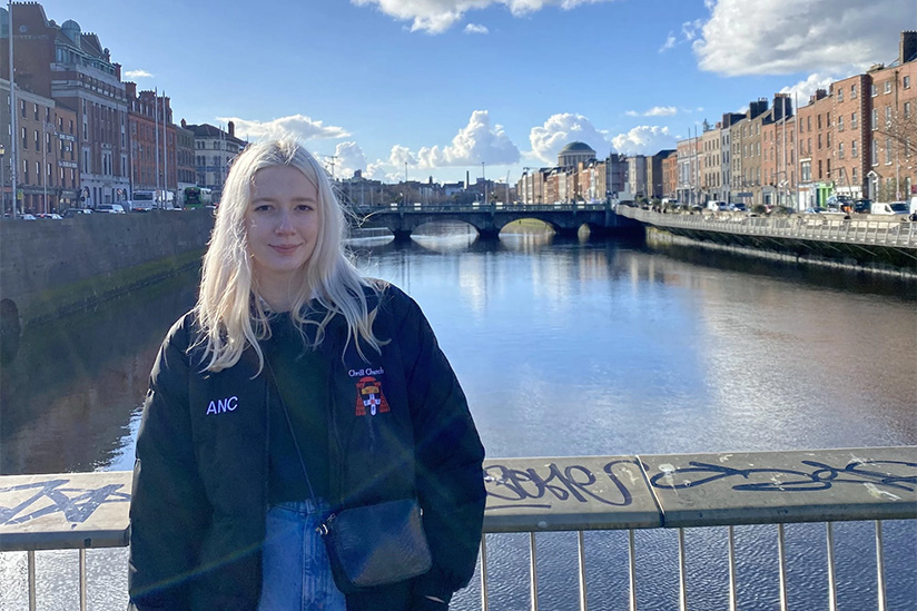 IYA alum, Amanda Curtis, on a bridge overlooking a river.