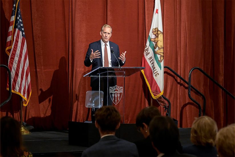 USC's Provost Andrew Guzman at a podium delivering remarks