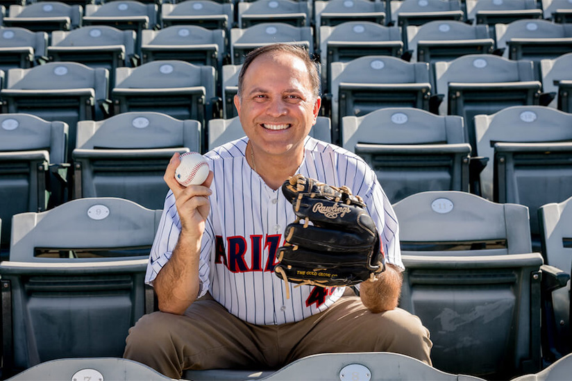 Ricardo Valerdi holding a baseball and baseball glove.