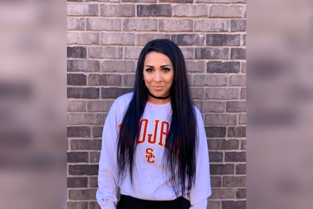 USC Price student, Veronica Frazier, in front of a brick wall