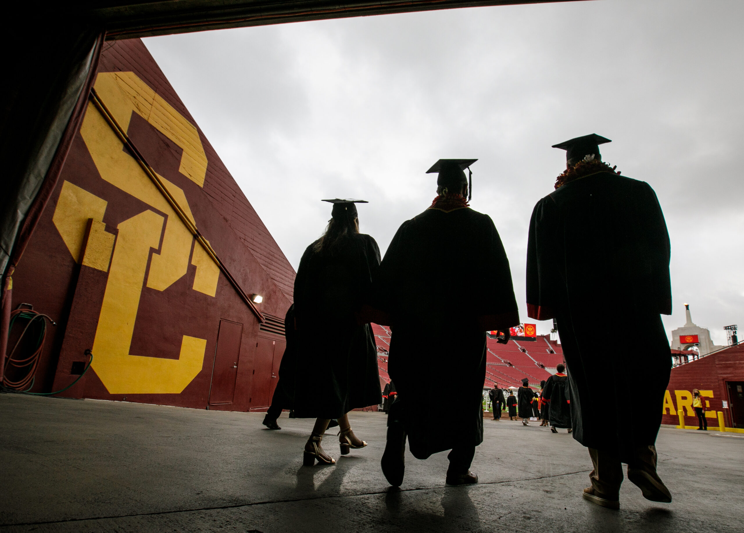 Trojan graduates walking out of USC tunnel at LA Memorial Coliseum.