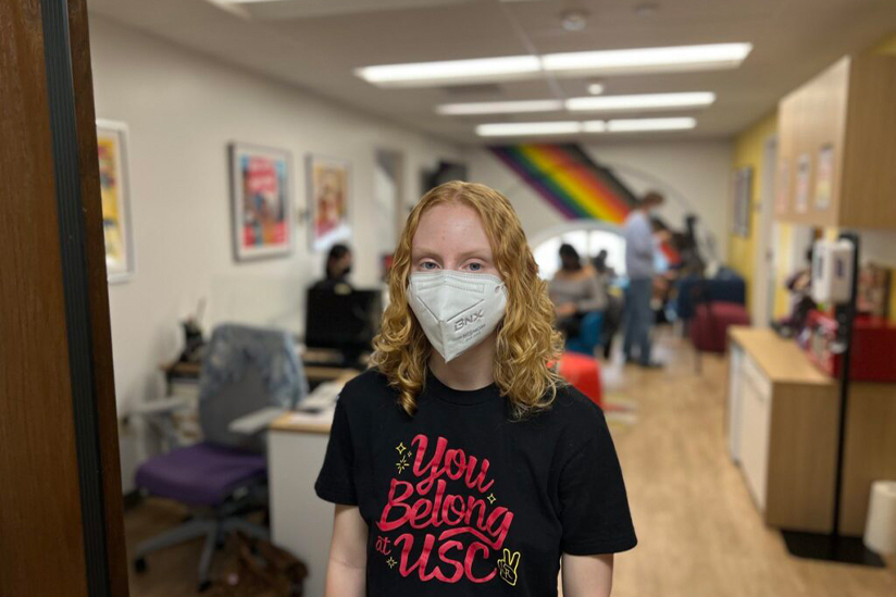 USC student wearing a mask in front of the LGBTQ+ Student Center