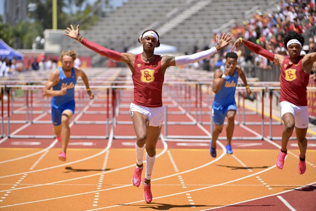 USC's Johnny Brackins with this arms outstretched as he wins his 110M hurdles race